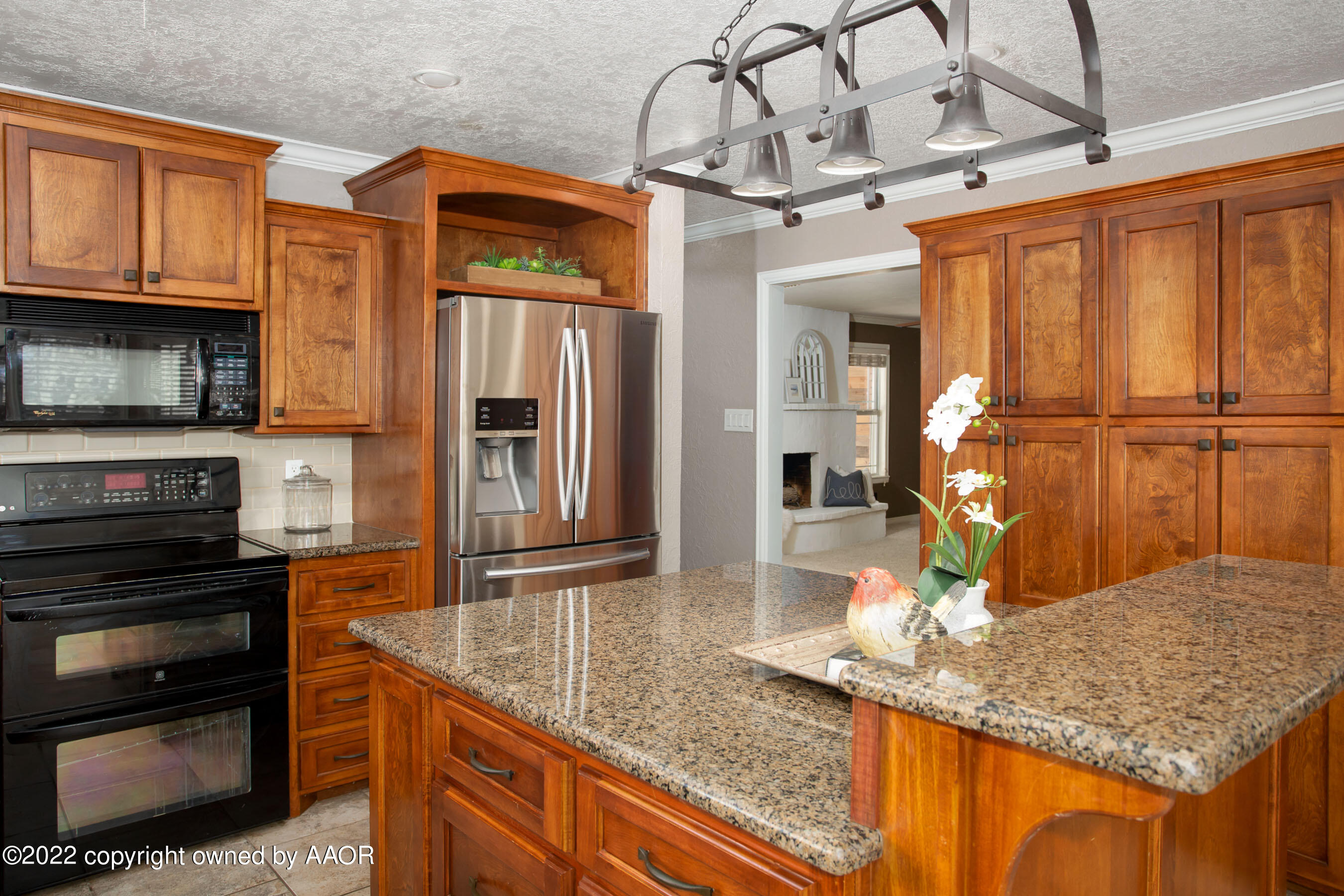 6301 Dreyfuss Road Amarillo, TX 79106 - Photo 12 of 34 a kitchen with stainless steel appliances granite countertop a sink refrigerator and cabinets