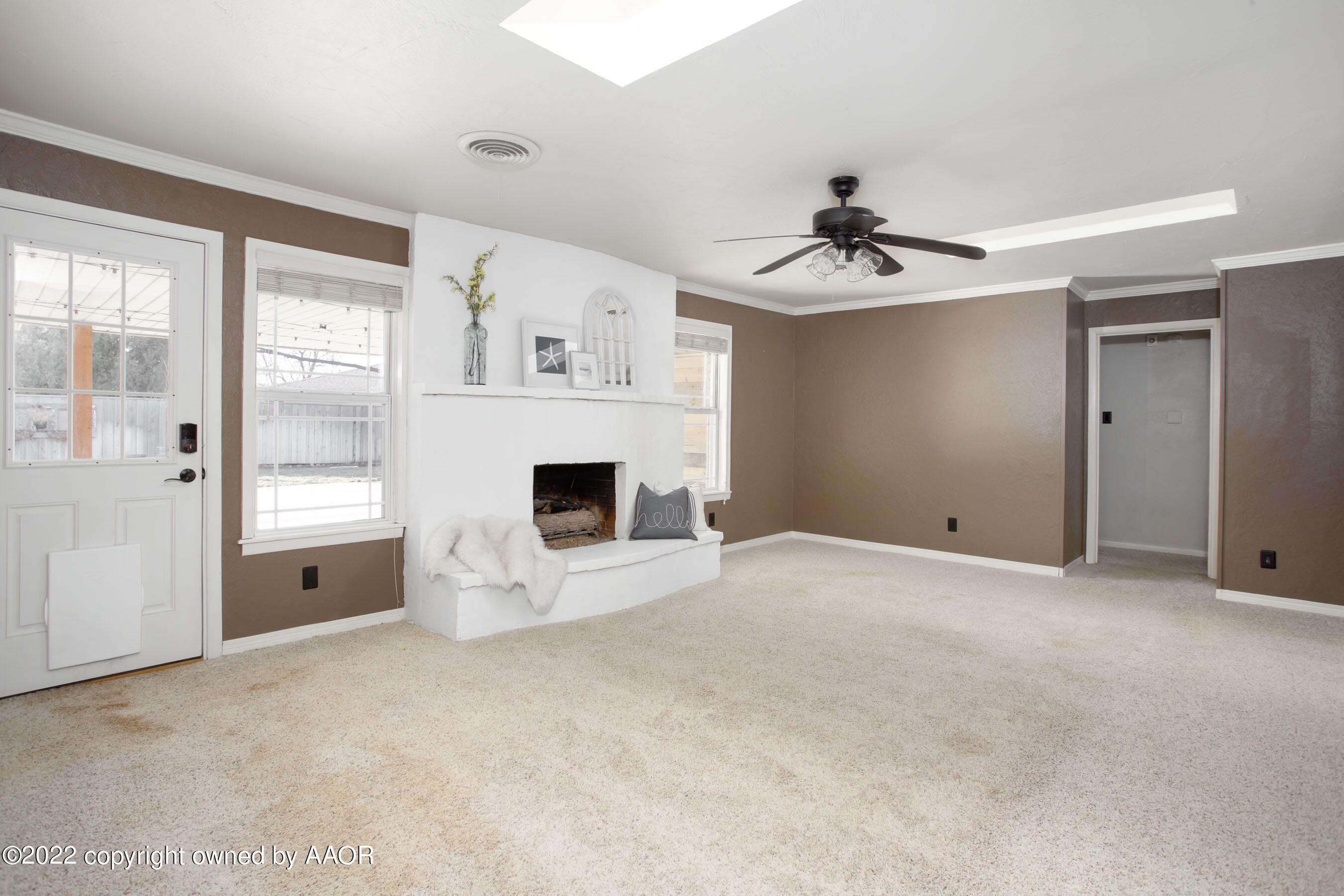 6301 Dreyfuss Road Amarillo, TX 79106 - Photo 7 of 34 a view of a livingroom with a fireplace cabinet and windows