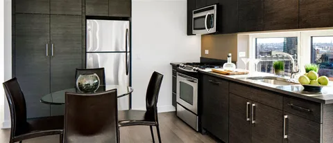 a kitchen with a refrigerator and a stove top oven