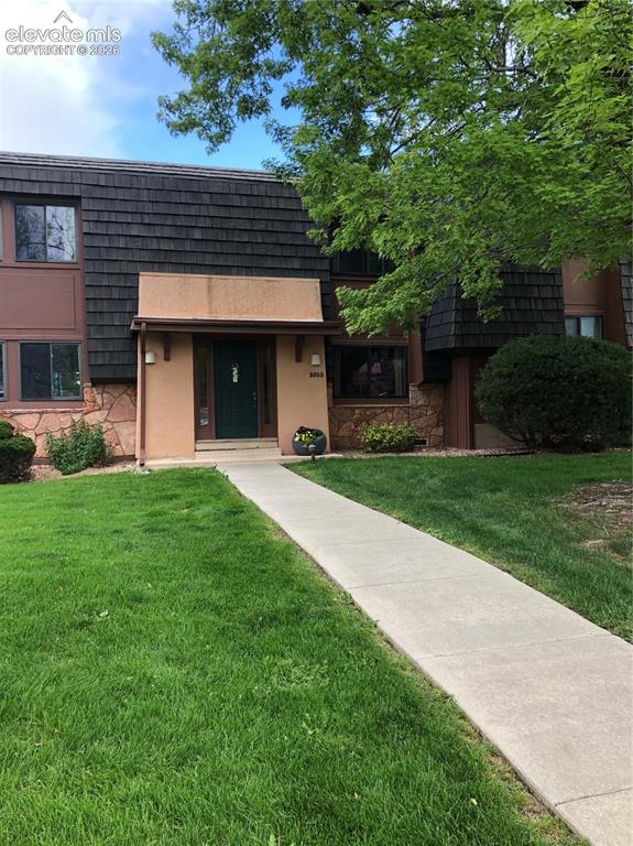 2953 Mesa Road, Unit B Colorado Springs, CO 80904 - Photo 2 of 23 a front view of a house with garden