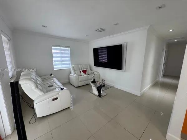 a living room with furniture and a flat screen tv