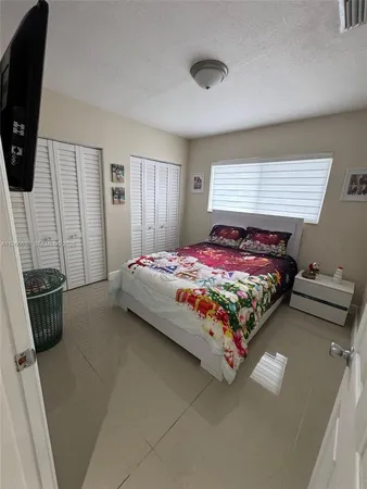 a bed sitting in a bedroom next to a window