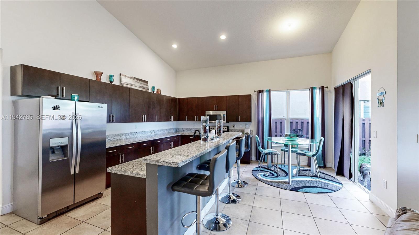 231 Northeast 33rd Terrace Homestead, FL 33033 - Photo 16 of 87 a kitchen with stainless steel appliances a refrigerator a stove a sink and a dining table with the view