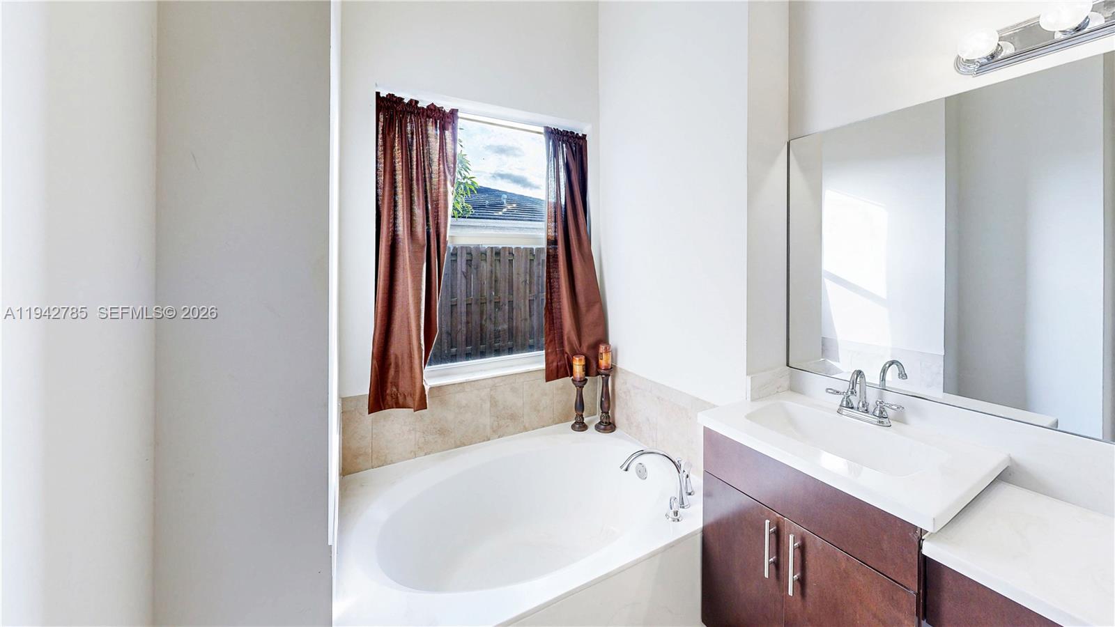231 Northeast 33rd Terrace Homestead, FL 33033 - Photo 28 of 87 a bathroom with a sink and a mirror