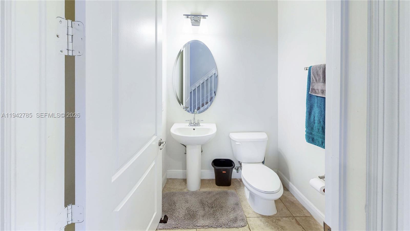 231 Northeast 33rd Terrace Homestead, FL 33033 - Photo 32 of 87 a bathroom with a toilet a sink and a mirror