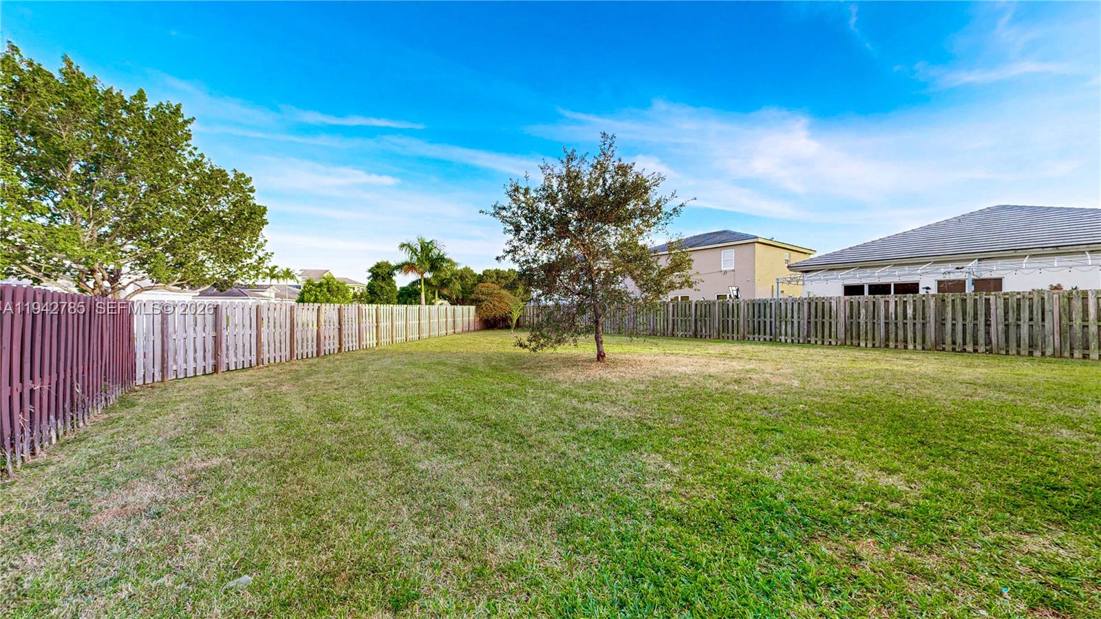 231 Northeast 33rd Terrace Homestead, FL 33033 - Photo 53 of 87 a view of backyard with wooden fence