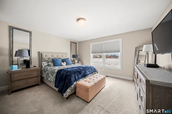 a bed room with a bed window and mirror
