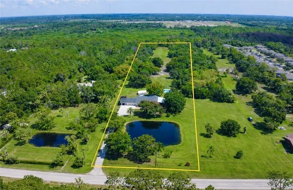 an aerial view of a house with a yard