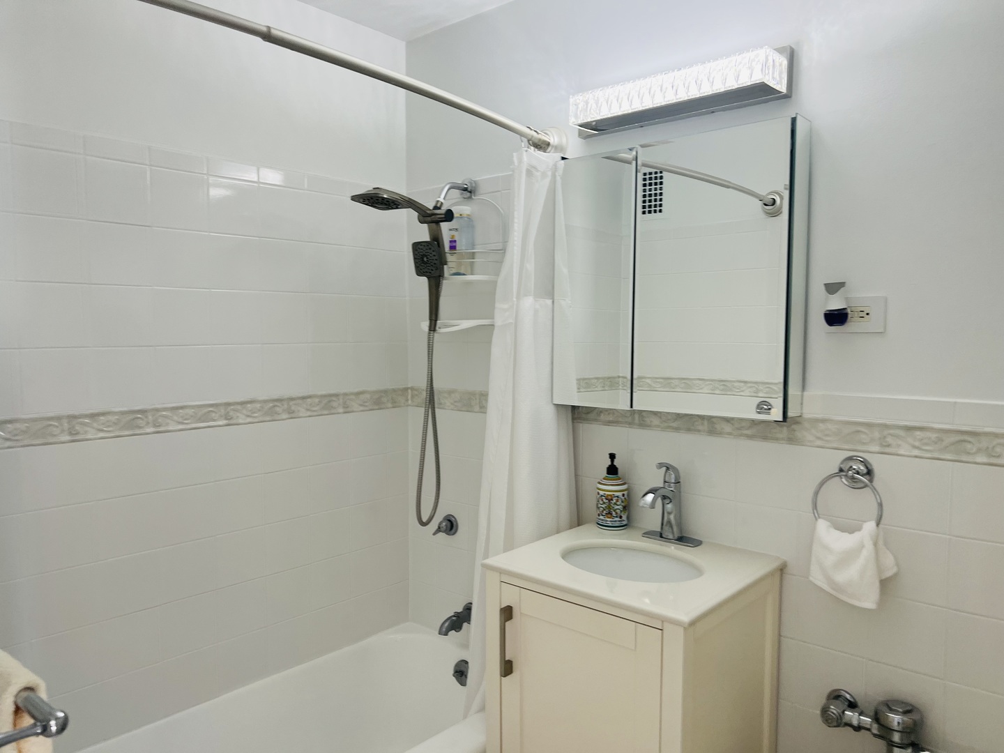 6030 North Sheridan Road, Unit 806 Chicago, IL 60660 - Photo 4 of 12 a bathroom with a sink a toilet and shower
