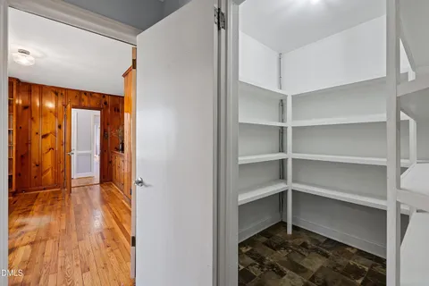 a view of a livingroom with wooden floor and a ceiling fan