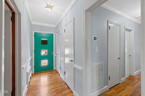 a view of empty room with wooden floor and window