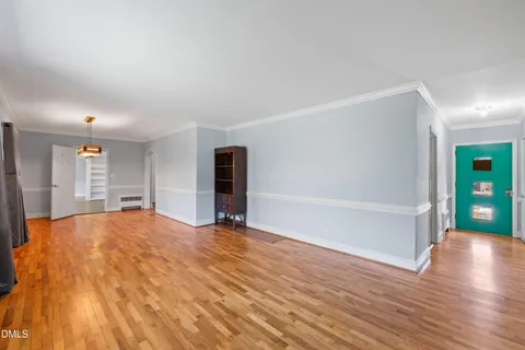 a view of an empty room with cabinet and a window