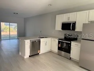 a view of a kitchen with electric appliances