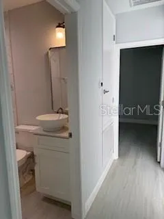a bathroom with a sink toilet and mirror