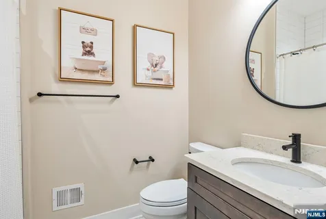 a bathroom with a sink a toilet and a mirror