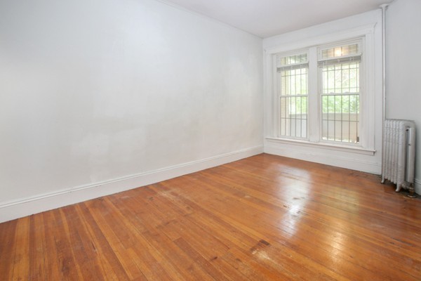 7-9 University Road Brookline, MA 02445 - Photo 11 of 17 an empty room with wooden floor and windows