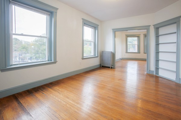 7-9 University Road Brookline, MA 02445 - Photo 3 of 17 a view of an empty room with wooden floor and a window