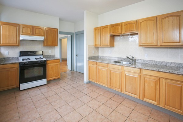 7-9 University Road Brookline, MA 02445 - Photo 5 of 17 a kitchen with stainless steel appliances granite countertop a sink and cabinets