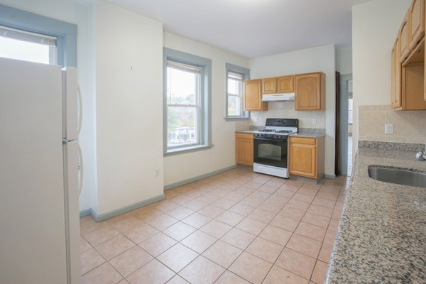 7-9 University Road Brookline, MA 02445 - Photo 6 of 17 a large kitchen with cabinets and stainless steel appliances