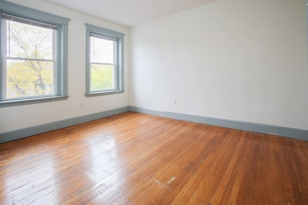 7-9 University Road Brookline, MA 02445 - Photo 7 of 17 an empty room with wooden floor and windows