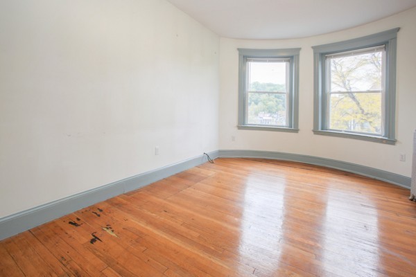 7-9 University Road Brookline, MA 02445 - Photo 8 of 17 an empty room with wooden floor and windows