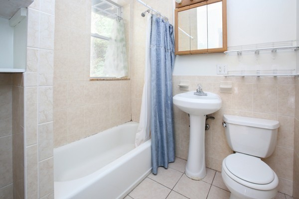7-9 University Road Brookline, MA 02445 - Photo 9 of 17 a white toilet sitting next to a bathroom sink