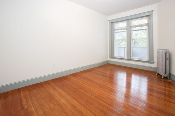 7-9 University Road Brookline, MA 02445 - Photo 10 of 17 an empty room with wooden floor and windows