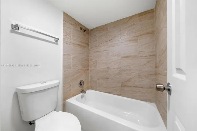 a bathroom with a toilet and a bathtub