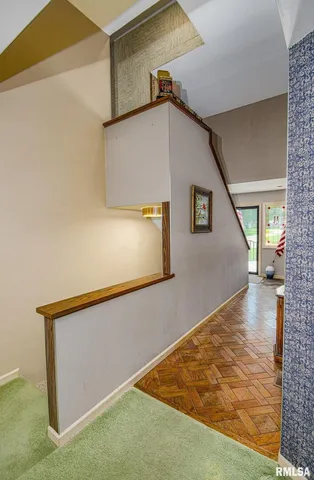a view of a big room with wooden floor and windows
