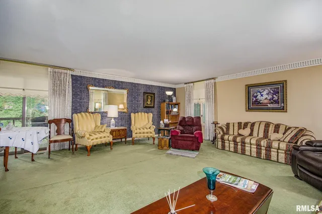 a living room with furniture rug and a large window