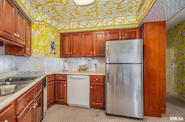 a kitchen with stainless steel appliances granite countertop a refrigerator and a sink