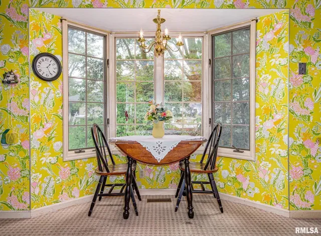 a view of a dining room with furniture and chandelier fan