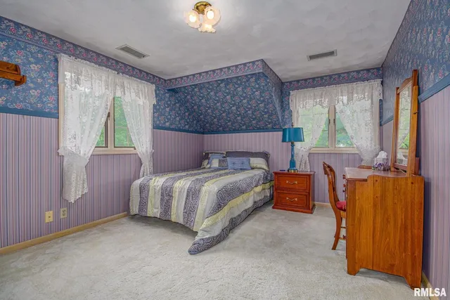 a bed room with a bed and a window