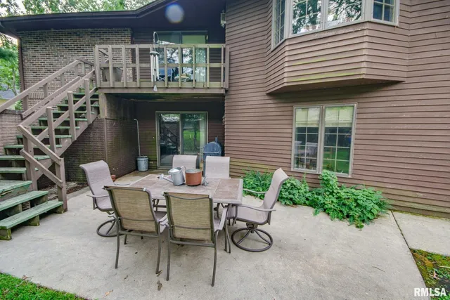a view of a house with patio and a yard