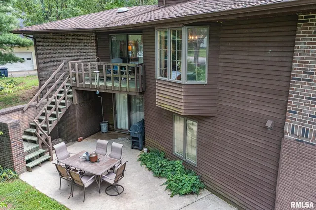 a front view of a house with outdoor seating