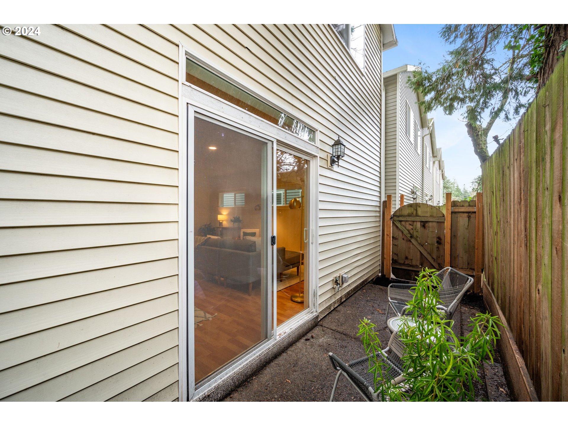 1186 Northeast 106th Avenue Portland, OR 97220 - Photo 21 of 22 a view of a porch with wooden floor and a potted plant