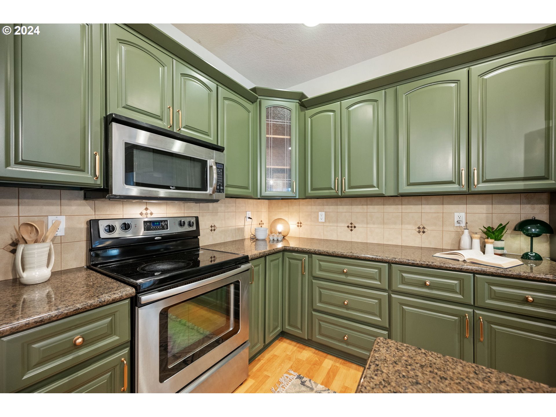 1186 Northeast 106th Avenue Portland, OR 97220 - Photo 8 of 22 a kitchen with stainless steel appliances granite countertop a stove a sink and a microwave
