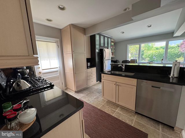 a kitchen with a sink stove and refrigerator