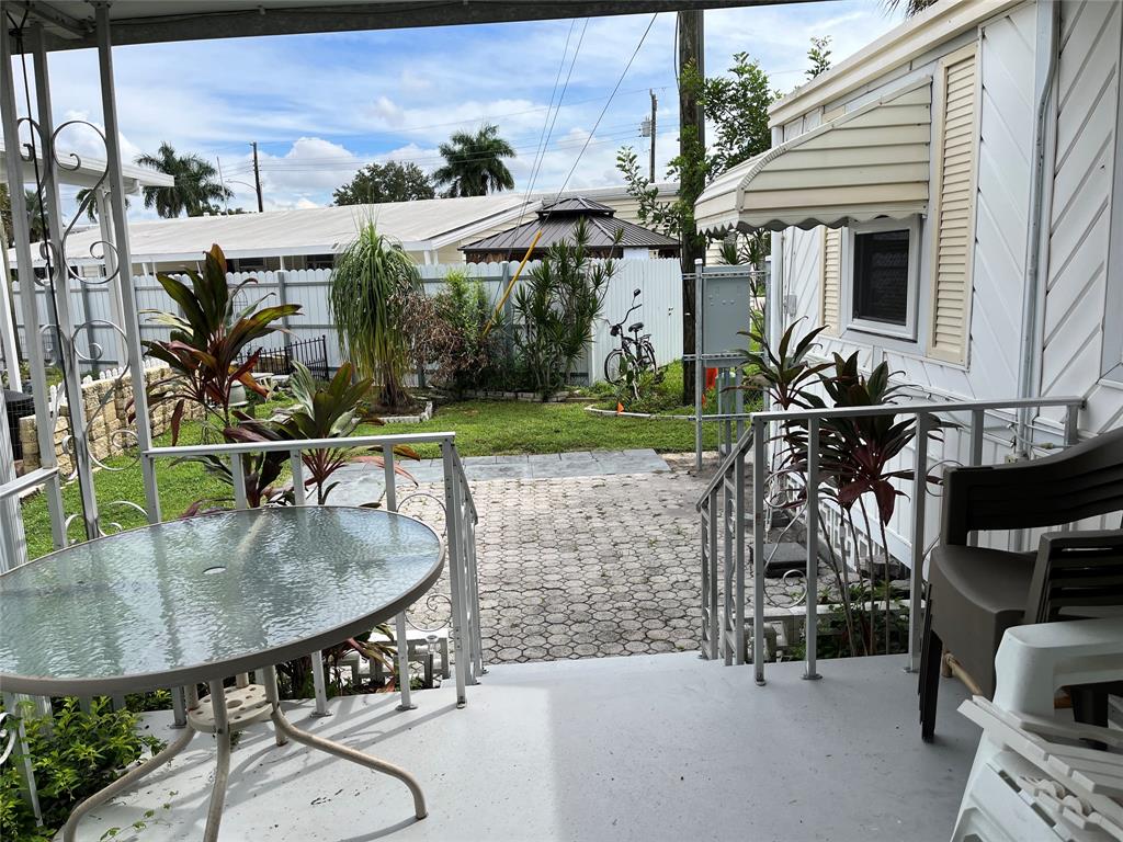 1910 Southwest 85th Terrace Davie, FL 33324 - Photo 13 of 22 a backyard of a house with table and chairs