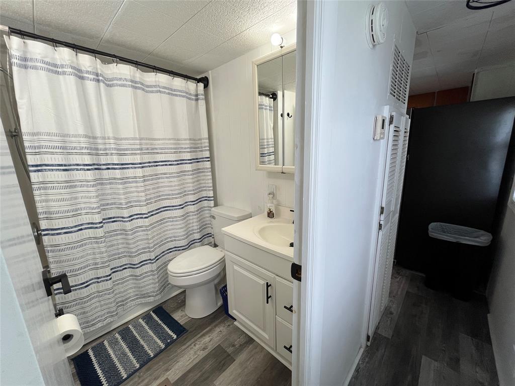 1910 Southwest 85th Terrace Davie, FL 33324 - Photo 21 of 22 a bathroom with a sink a toilet and shower curtain