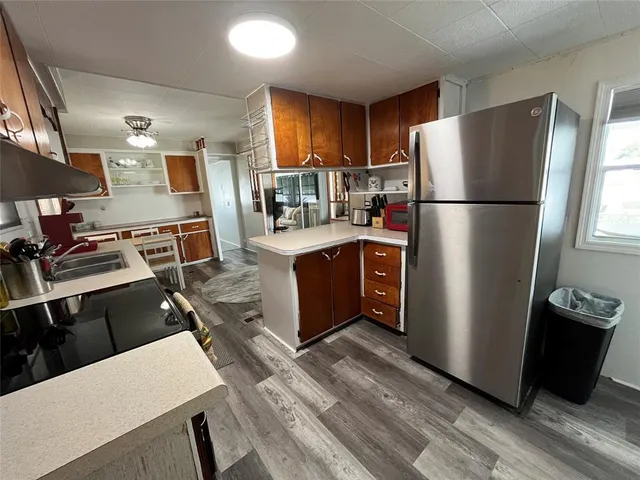 a kitchen with stainless steel appliances a stove a sink and a microwave
