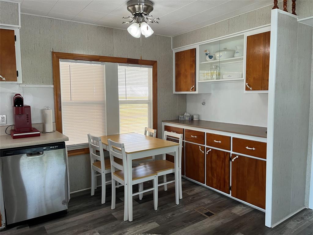 1910 Southwest 85th Terrace Davie, FL 33324 - Photo 8 of 22 a kitchen with a table chairs a sink dishwasher window and cabinets