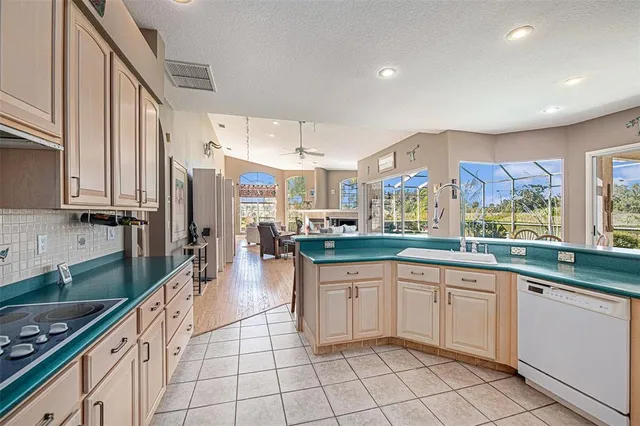 a living room with fireplace furniture and large windows
