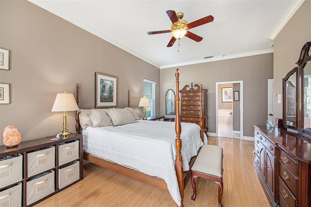 331 Lewis Road Lithia, FL 33547 - Photo 21 of 87 a bedroom with a bed a dresser and potted plants on the dresser