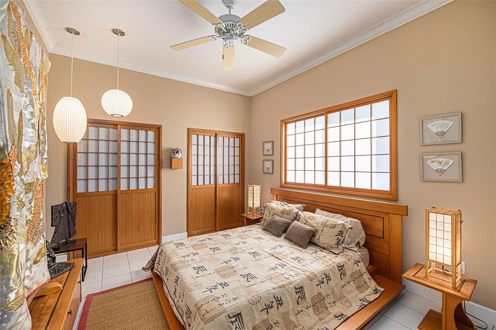 331 Lewis Road Lithia, FL 33547 - Photo 23 of 87 a bedroom with a bed and a chandelier