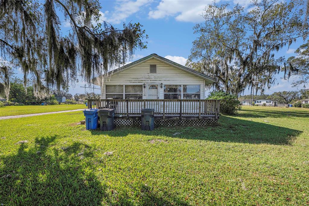 331 Lewis Road Lithia, FL 33547 - Photo 29 of 87 a view of a house with pool and a yard