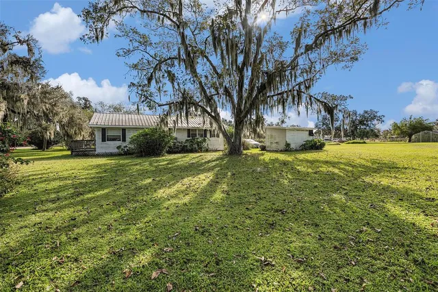 a dining room with furniture a chandelier and window