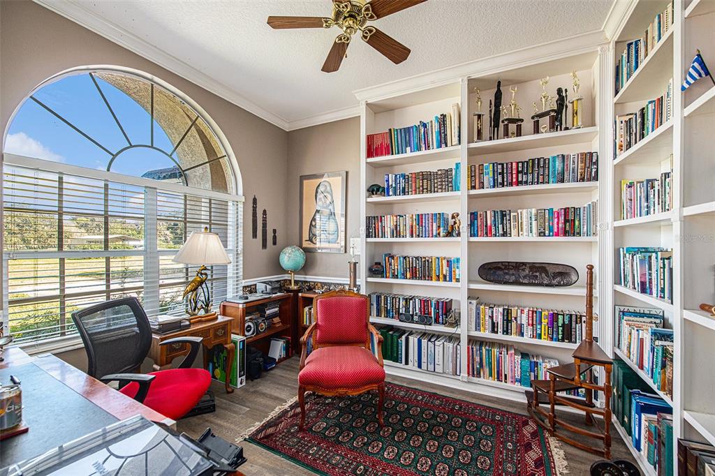 331 Lewis Road Lithia, FL 33547 - Photo 6 of 87 a living room with lots of furniture and a book shelf
