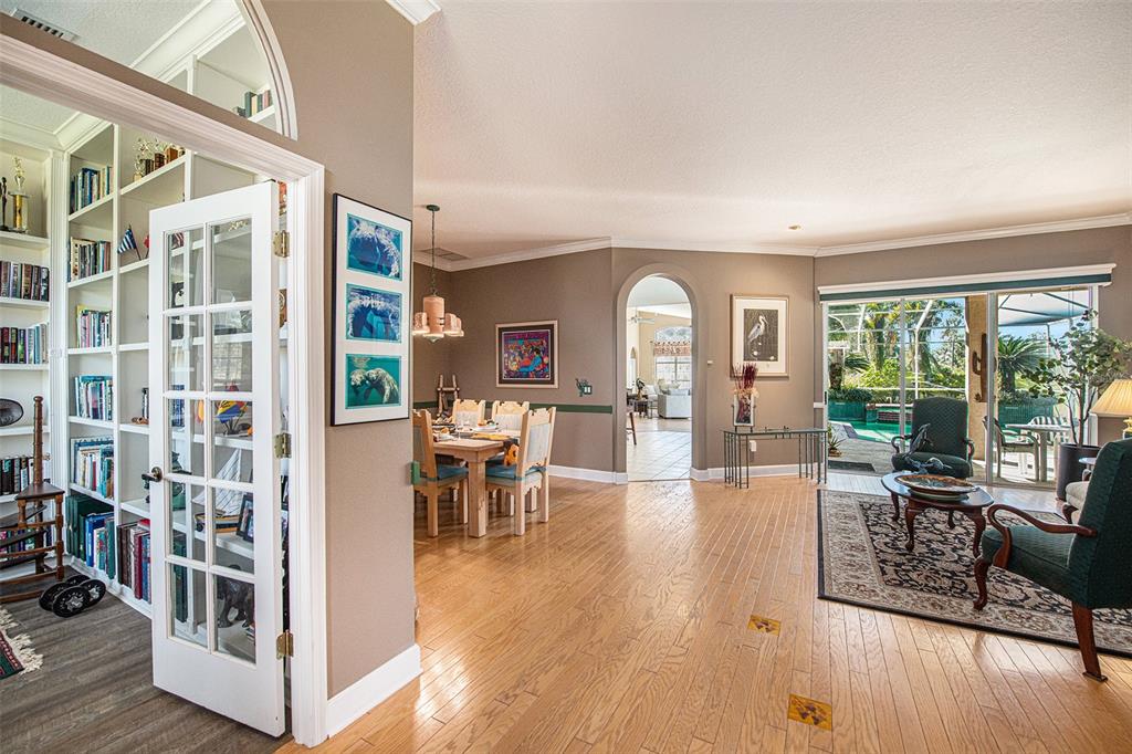 331 Lewis Road Lithia, FL 33547 - Photo 7 of 87 a view of a livingroom with furniture wooden floor and a floor to ceiling window
