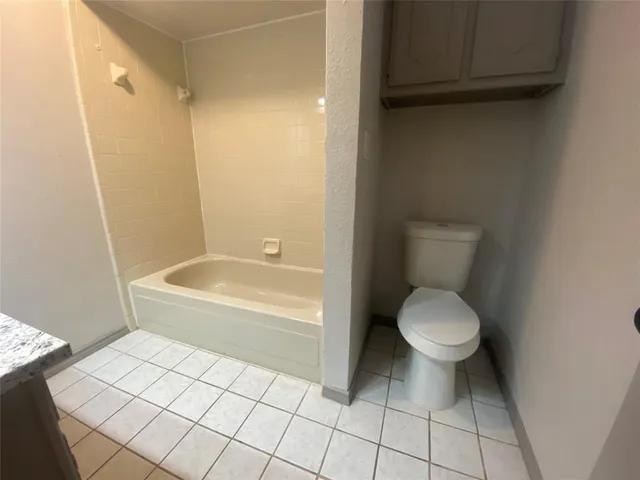 a bathroom with a sink a toilet and bathtub